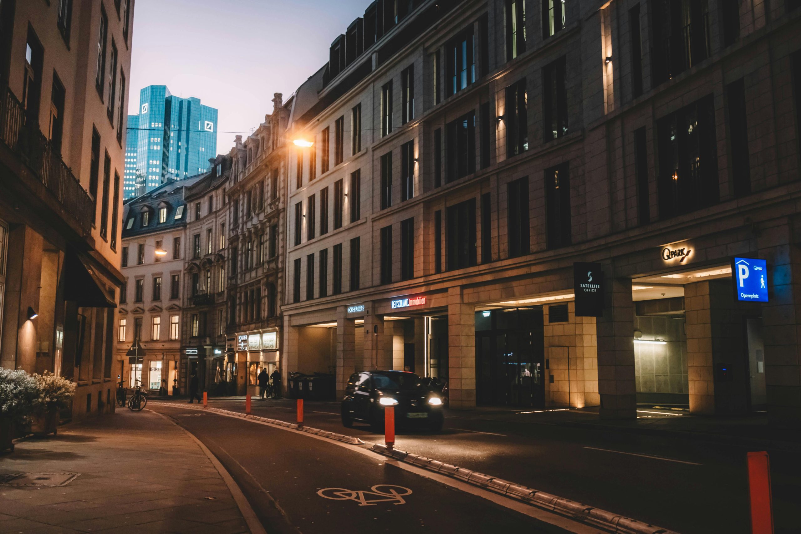 Elegant street view of Frankfurt Am Main at dusk, showcasing modern architecture.